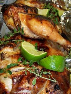 grilled chicken with limes and herbs on foil