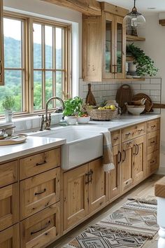 a kitchen filled with lots of wooden cabinets and counter top space next to a window