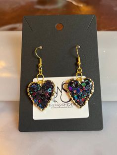 Step into a world of enchantment with our Sparkling Dreams earrings, featuring charming hearts adorned with dazzling glitter in various colors. Each pair is a celebration of individuality, allowing you to express your style with a burst of color and sparkle. Handcrafted with precision, these earrings are versatile enough to complement both casual and formal looks. Key Features: *Handcrafted heart earrings with a variety of glitter colors *Lightweight and comfortable for extended wear *Secure earring backs for a worry-free experience *Unique and eye-catching design for a statement look Materials: These earrings are crafted using high-quality materials, with each heart showcasing a different glitter color. Choose the shade that resonates with your mood or outfit, and let your personality shi Heart Cut Earrings With Heart Charm For Party, Heart Shaped Pierced Jewelry For Party, Double Heart Charm Earrings For Party, Sparkling Drop Earrings For Gift, Heart Shaped Pierced Party Jewelry, Handmade Heart Drop Earrings For Party, Sparkling Drop Earrings As Gift, Handmade Party Heart Drop Earrings, Valentine's Day Celebration Dangle Earrings