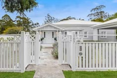 a white picket fence in front of a house