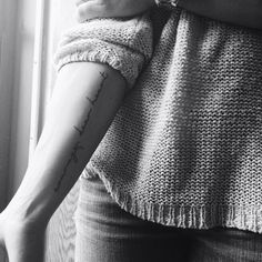 a woman with a tattoo on her arm