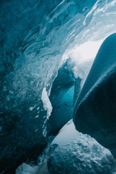 the inside of an ice cave with blue water