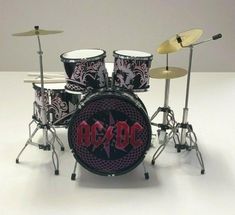 a set of drums with the word ac / dc on it