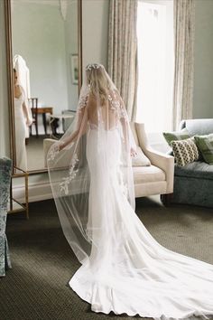 the bride is getting ready to walk down the aisle in her wedding dress and veil