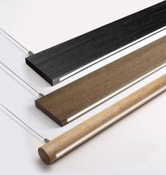 two different types of wood and metal on a white surface, one has a brown strip