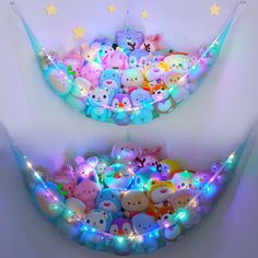 there are many stuffed animals in the bed with light up lights on it's sides