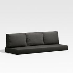 a black couch sitting on top of a white floor