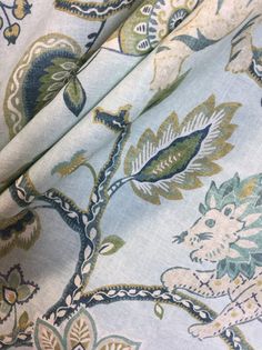 an image of a blue and green floral print fabric with flowers on the bottom half