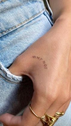 a woman's hand with a small tattoo on her left wrist and the word love written