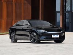 a black car parked in front of a building