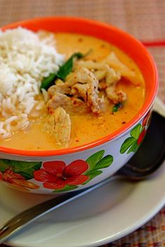 a bowl filled with rice and meat on top of a plate