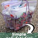 a basket filled with plastic bags sitting on top of a gravel covered ground next to another bag