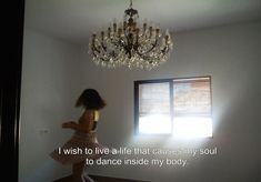 a woman standing in front of a chandelier with the words i wish to live life that cause my soul to dance inside my body