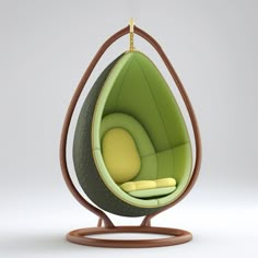 a green and brown hanging egg chair on a wooden stand with a yellow pillow in the middle