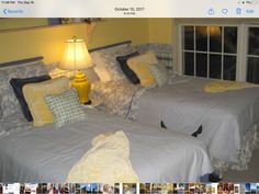 two beds in a room with yellow walls and blue comforters on top of them