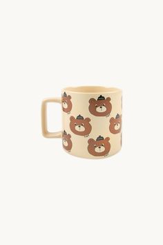 a coffee cup with a bear pattern on it