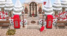 a red phone booth sitting in front of a christmas tree filled with snow covered trees