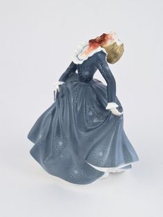 a figurine of a woman in a blue dress