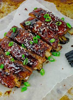 ribs with sesame seeds and green onions on parchment paper