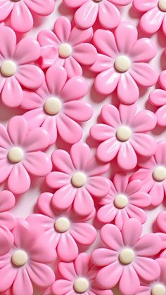 pink and white flowers are arranged in the shape of an abstract pattern on a surface