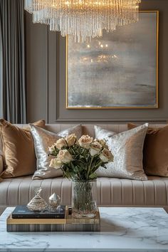 a living room filled with furniture and a chandelier hanging over the top of it