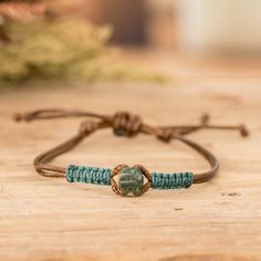 a couple of bracelets sitting on top of a wooden table