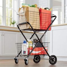 a shopping cart filled with grocery bags on top of a hard wood floor