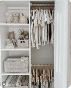 an organized closet with clothes and baskets