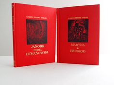 two red books sitting next to each other on a white surface with the cover open