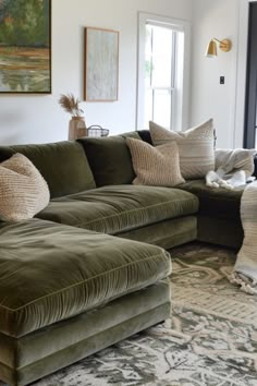 a living room filled with furniture and pillows