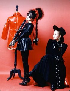 two mannequins dressed in black and red