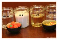 four jars with different types of food in them and labeled on the top one containing milk, oranges, and other ingredients