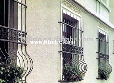 an apartment building with iron balcony railings and flower boxes on the balconies