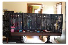 a room filled with lots of jewelry on top of a wooden table