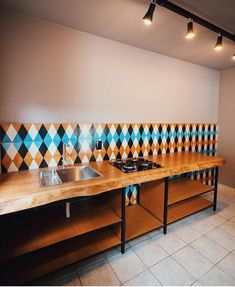 a kitchen with two sinks and tiled backsplash