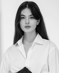 a woman with long hair wearing a white shirt