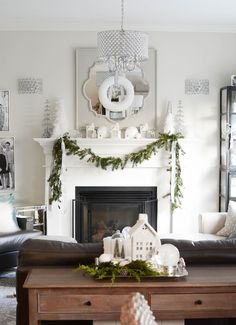 a living room filled with furniture and a fire place covered in greenery next to a fireplace