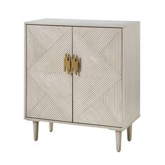 a white cabinet with gold handles and geometric designs on the doors, it is isolated against a white background