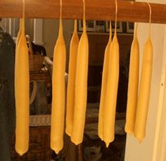 a person standing in front of a rack with yellow objects hanging from it's sides