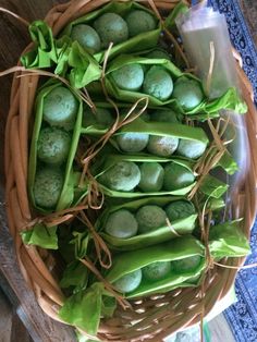 a basket filled with green beans and pea pods