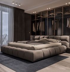 a large bed sitting in the middle of a bedroom next to a walk in closet