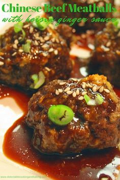 meatballs with sauce and green onions on a plate