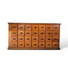 an old wooden cabinet with many drawers