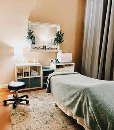 a bedroom with a bed, desk and mirror