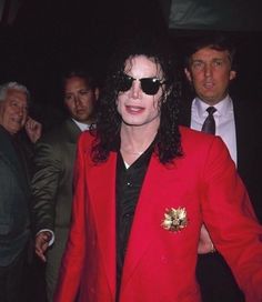 a man in a red suit and sunglasses