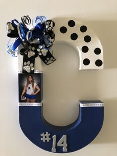 the letter c is decorated with black and white polka dots, blue ribbon, and a bow