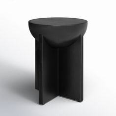 a black stool with two curved legs