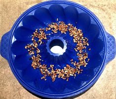 a blue bowl filled with nuts on top of a counter