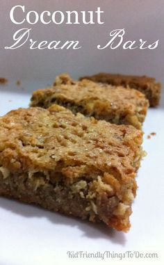 two pieces of granola bars sitting on top of a white plate with the words coconut cream bars