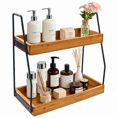 two tiered wooden shelf with soaps, lotion bottles and candles on it